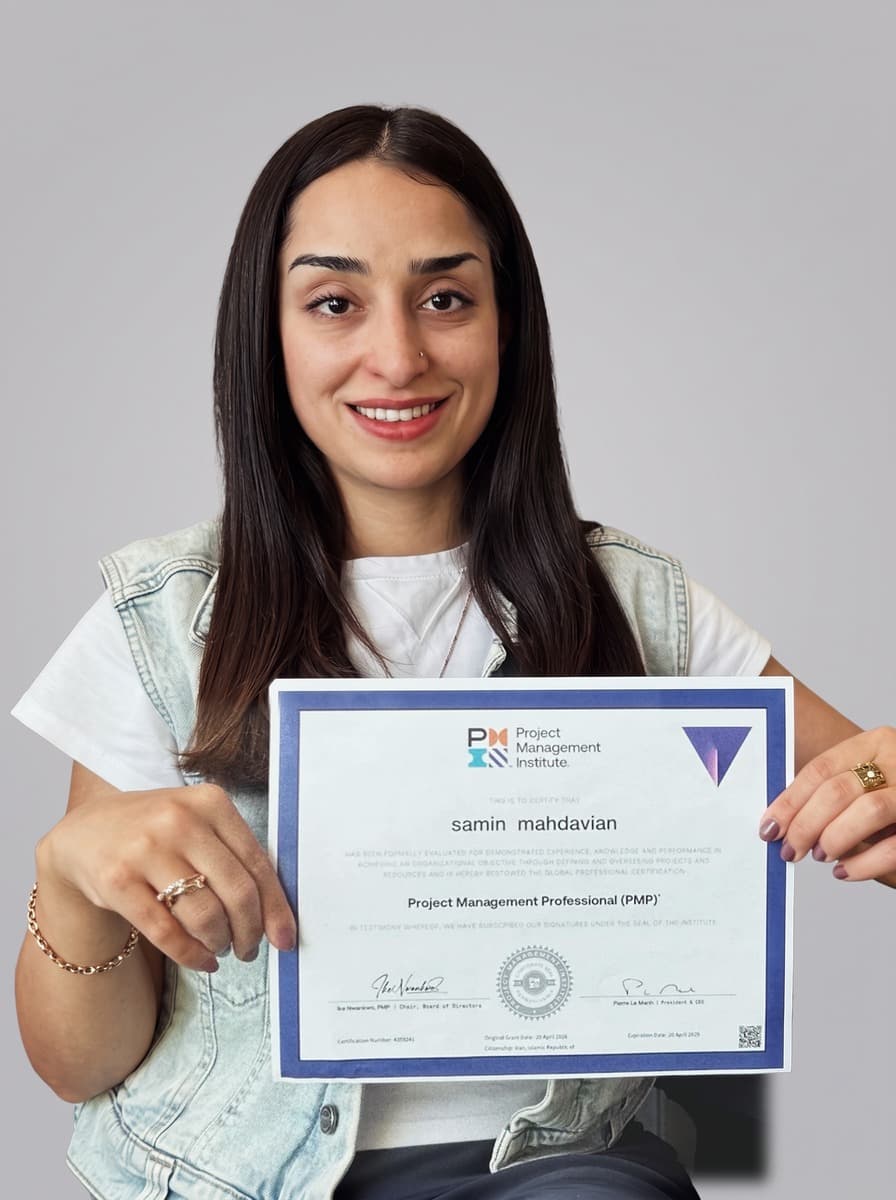 Samin Mahdavian, holding their PMP certificate.